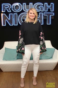 a woman standing in front of a couch with the words rough night written on it