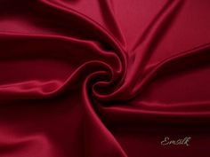 a close up shot of a red fabric with the word emall written on it