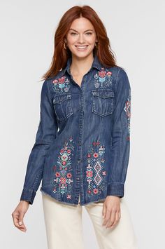 The Myra Denim Shirt beckons warmer weather with bursts of vibrant color against deep indigo. This classic, form-flattering shirt is crafted from a comfortable cotton blend that's been enzyme washed for a soft, distressed finish. But its embroidered floral detailing in a brilliant spring palette is the star of the show—featured at the front and sleeves, and making a beautifully bold statement across the back panel. Flap chest pockets adorned with real abalone snap buttons and a raw-edged hem fin Dark Wash Cotton Denim Top For Fall, Dark Wash Cotton Top For Fall, Relaxed Fit Cotton Denim Top For Fall, Fall Cotton Shirt In Dark Wash, Medium Wash Cotton Top For Fall, Spring Cotton Indigo Top, Dark Wash Washed Shirt For Spring, Fall Dark Wash Cotton Shirt, Dark Wash Cotton Shirt For Fall