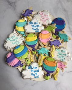 decorated cookies are arranged in the shape of hats, balloons and other things that say oh the places you'll go