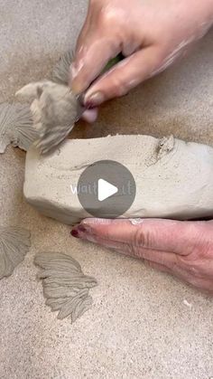 someone is making something out of clay on the floor with their hands and thumbnails