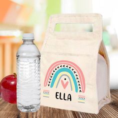 "This personalized pastel rainbow lunch bag features a durable canvas fabric outer shell with insulated lining, lightly padded handles, and a velcro closure. Perfect for school, camp, sports and more!  Optional - add a sheet of coordinating name labels. 𝗣𝗘𝗥𝗦𝗢𝗡𝗔𝗟𝗜𝗭𝗘 𝗬𝗢𝗨𝗥𝗦 * Add the name of your choice (up to 12 letters). *Character limit includes spaces & punctuation. *Name will be printed in colors and lettering shown. *No special characters, accented letters or symbols 𝗟𝗨𝗡𝗖? Pastel Pink Rainbow, Rainbow Notebook, Customized School Supplies, Girl School Supplies, School Camp, Dance Camp, Kids Diary, Little Sister Gifts, Kids Lunch Bags