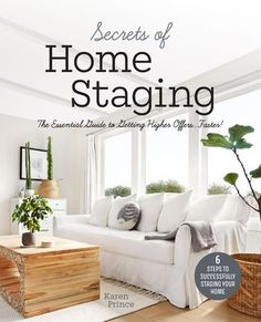 a living room filled with white furniture and lots of plants on top of the table