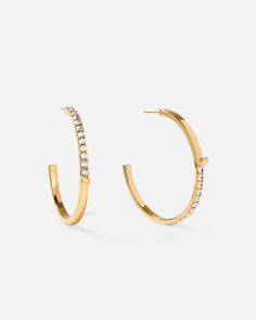 Classic silhouettes with curls detailing give these hoop earrings a minimalistic style perfect for any time. Elevate your look with these color block earrings, inspired by a subversive-basic concept, effortless yet contemporary.
 
Size: 3×43mm
Stone Color: Shiny White
Material: Crystals, 18k Gold Plated On Brass Modern Hoop Earrings For Everyday Elegance, Modern Single Hoop Earring For Everyday Elegance, Chic Hoop Wrap Earrings For Everyday, Modern Diamond Hoop Earrings For Everyday Luxury, Modern Yellow Gold Hoop Wrap Earrings, Modern Everyday Luxury Hoop Earrings, Earrings With Crystals, Minimalistic Style, Crystal Hoop Earrings