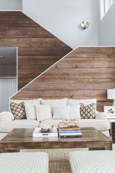 a living room with wood paneling on the walls