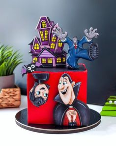 a red cake decorated with cartoon characters on it