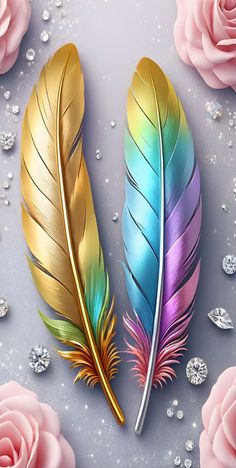 two colorful feathers sitting next to each other on top of a table with pink roses