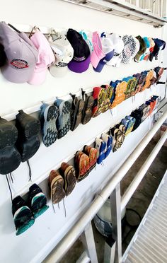 there are many pairs of shoes hanging on the wall