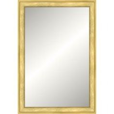 a gold framed mirror on a white wall