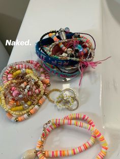 bracelets and rings are sitting on a table