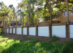 a row of wooden fences in front of a house