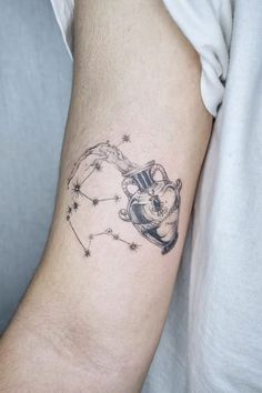 a man's arm with a small mouse tattoo on it