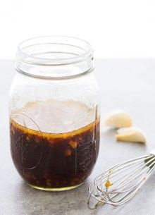 a glass jar filled with liquid and whisks