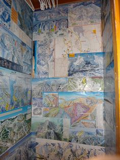 a bathroom with many maps on the wall