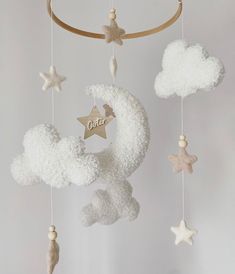 a baby crib mobile with stars and clouds