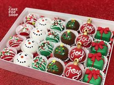 a box filled with christmas chocolates on top of a red table