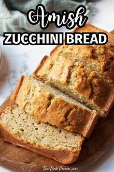 sliced zucchini bread sitting on top of a wooden cutting board