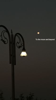 a street light with the moon in the background and an inspirational quote above it that reads, to the moon and beyond