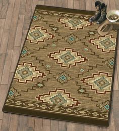 a brown rug with blue and green designs on it next to a pair of boots