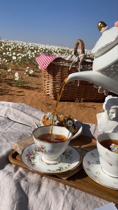 tea being poured into a cup on a tray