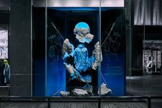 a glass display case with an image of a man in blue on it's back