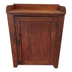 an old wooden cabinet with a door on the front and drawer at the bottom, isolated against a white background