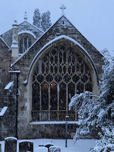 a church with snow falling on the ground