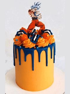 a dragon ball cake with blue and orange icing on it's bottom tier