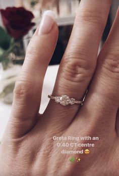 a woman's hand with a diamond ring on it, and the words great ring with an 0 40 ct centre diamond