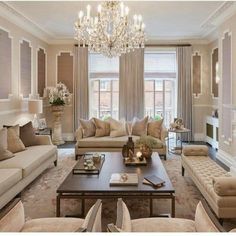 a living room filled with furniture and a chandelier