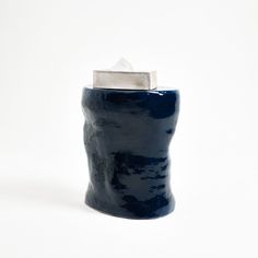 a blue ceramic container with a silver lid on a white background, it looks like something out of space