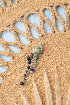 Indulge in the beauty of the sea with our Pacifica Collection! Each piece is meticulously handcrafted with stunning shades of blue, capturing the essence of ocean waves and clear skies. Sterling Silver (Lead & Nickel Free) Lapis Lazuli, Jasper, Aquamarine 22-24" adjustable with sterling silver lobster claw clasp We hand select our natural materials, thus there may be slight variations in color and/or size that will not detract from the overall aesthetic. Our unique handcrafted designer jewelry f Adjustable Blue Nature-inspired Necklace, Blue Adjustable Nature-inspired Necklace, Blue Natural Stones Long Drop Jewelry, Blue Long Drop Jewelry With Natural Stones, Blue Long Drop Natural Stone Jewelry, Handmade Blue Long Drop Necklace, Handmade Blue Necklace With Long Drop, Handmade Blue Necklaces With Long Drop Shape, Artisan Blue Jewelry For Beach