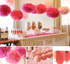 a table topped with lots of pink pom poms