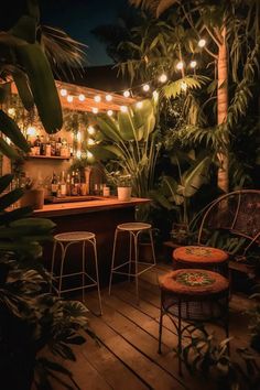 an outdoor bar is lit up at night with lights strung from the ceiling and potted plants