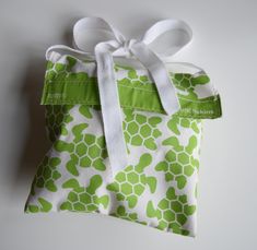 a green and white bag with a bow on it