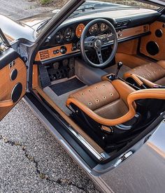 the interior of a car is shown with leather seats and dashboards, including an automatic steering wheel