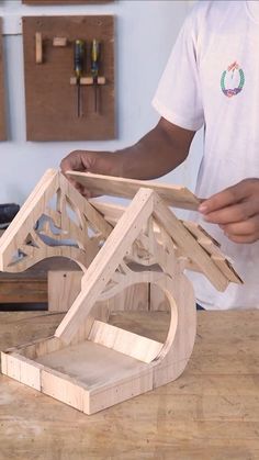 a man is making a house out of wood