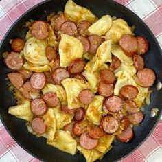 a skillet with sausage and pineapple slices on the side, ready to be cooked