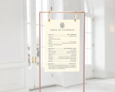 a table of contents sign hanging on a gold frame