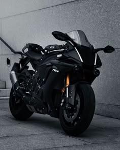 a black motorcycle parked in front of a building