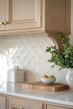 a vase with some fruit on top of a kitchen counter