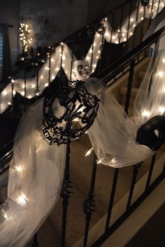 a staircase decorated for halloween with white lights