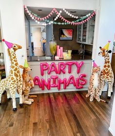 three stuffed giraffes are standing in front of a party animal sign