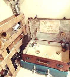 two suitcases sitting next to each other in a room with wooden crates on the floor