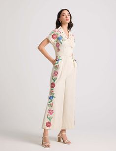 Indulge in the elegance of an ivory cotton twill jumpsuit, adorned with intricate floral applique and delicate beadwork. Featuring a chic cutwork detail collar, this jumpsuit effortlessly combines sophistication with modern flair. Elegant Floral Print Jumpsuits And Rompers, Elegant Floral Jumpsuits And Rompers For Spring, Embroidered Cotton Jumpsuits And Rompers For Spring, Elegant Cotton Jumpsuits And Rompers For Spring, Embroidered Fitted Full-length Sets, Festive Semi-stitched Pant Set With Floral Embroidery, Off-white Floral Embroidered Mulmul Set, Applique Jumpsuit, Embroidery Jumpsuit