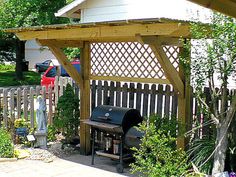 an outdoor grill in the middle of a garden