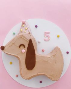 a cake shaped like a dachshund with sprinkles on it