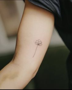 a single flower tattoo on the arm