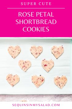 heart shaped shortbread cookies on a white plate with pink background and text overlay reading super cute rose petal shortbread cookies