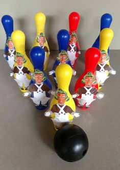 a group of plastic bowling pins with cartoon characters on them